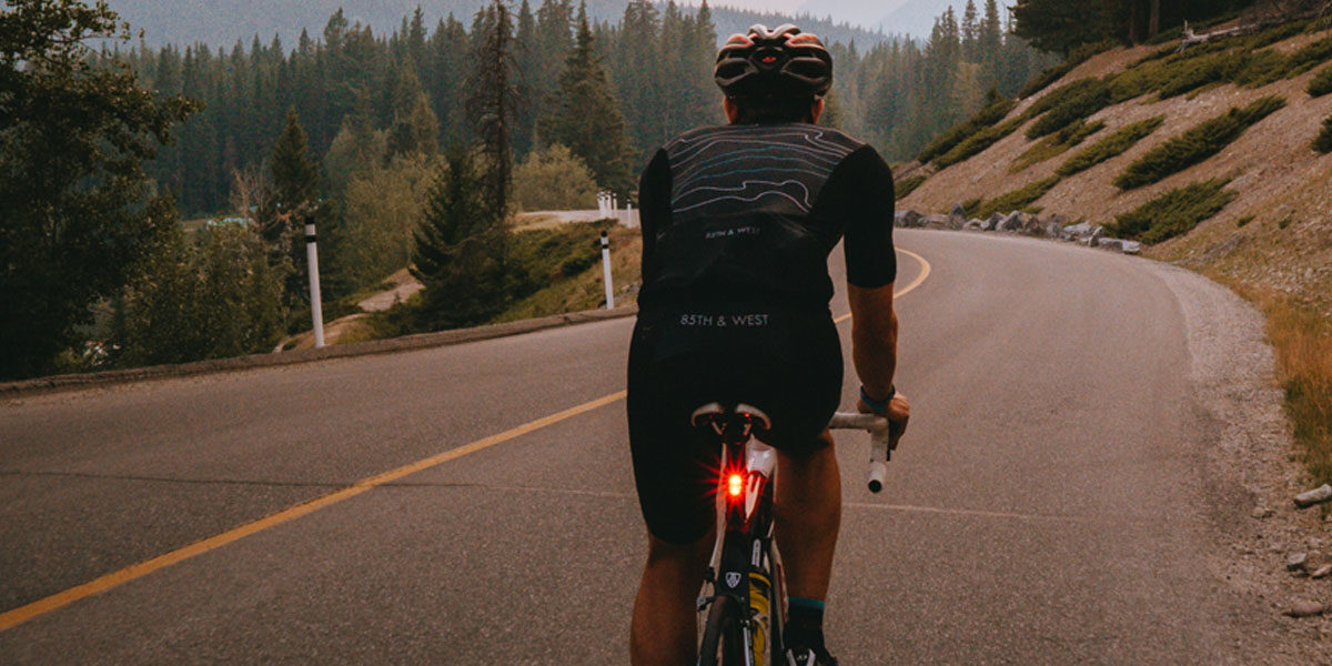 Man cycling down hill at dusk